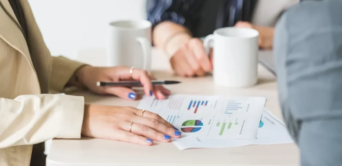 Two professionals discussing a flowchart illustrating the steps of buying a business in Chicago.